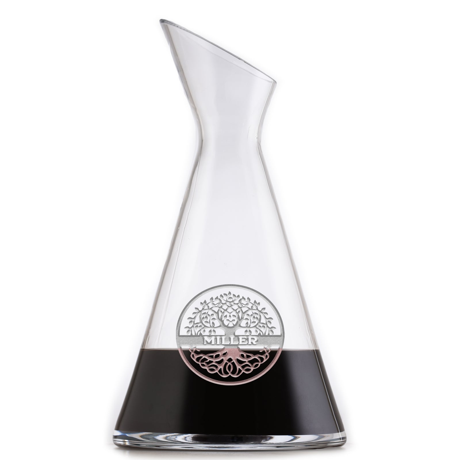 Slant wine carafe deep-carved with a family tree in a circle above a last name, filled with a dark drink, on a white background.