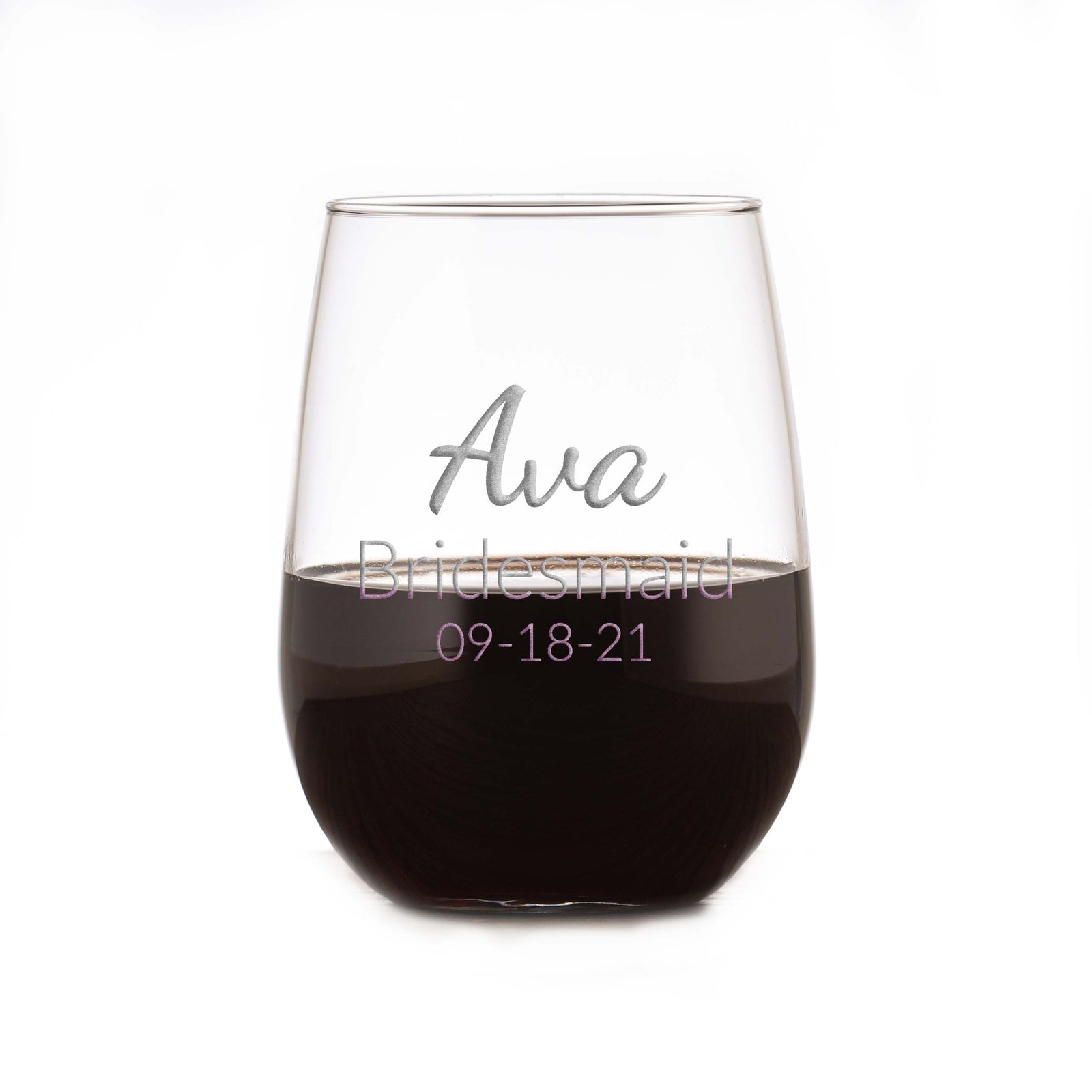 Stemless wine glass filled with red wine, deep-etched with "Ava, Bridesmaid, 09-18-21," on a white background.